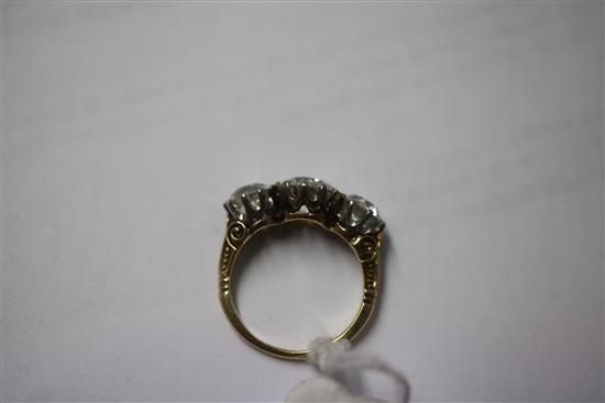 A Victorian style gold three stone diamond ring, size O.